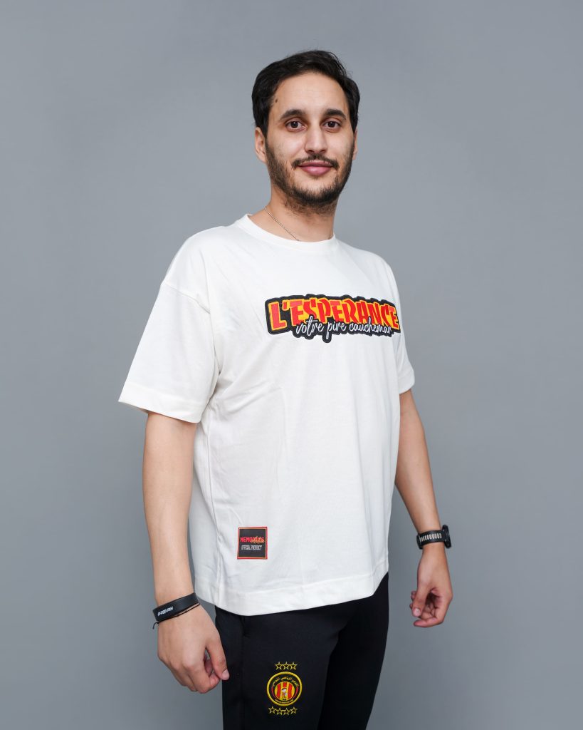 Supporter portant le T-shirt oversize Espérance 2024 blanc avec imprimé L’ESPÉRANCE